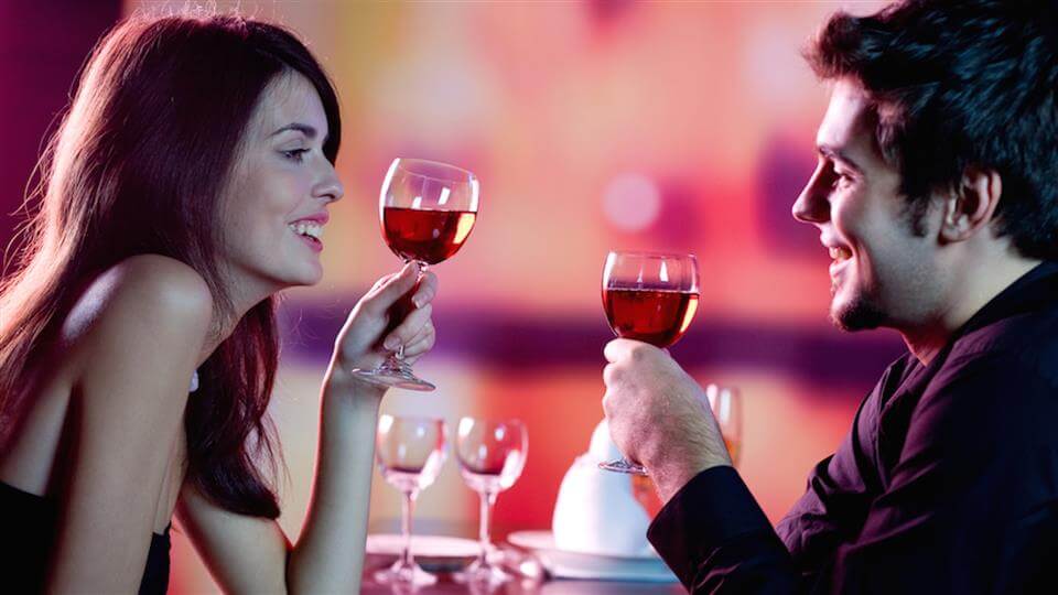 Signs-a-Woman-is-Sexually-Attracted-to-You-Woman-and-a-Man-Toasting-with-Wine